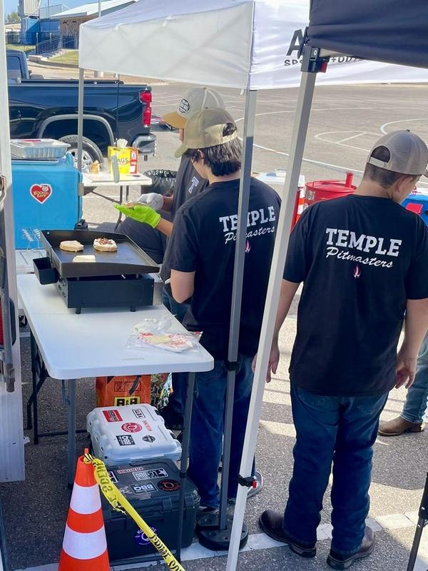 Pitmasters team members preparing their grilled cheese