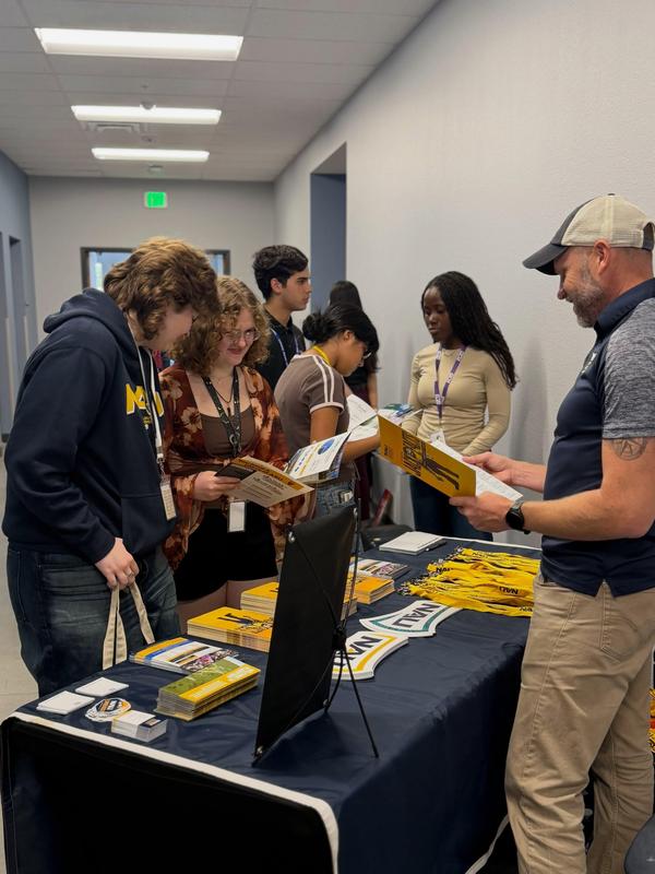 photos of students talking to a  college rep