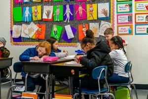 Arco Iris students work on assignments in their classroom.