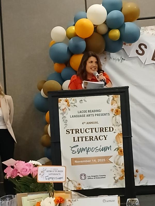 Claudia Barba accepts her award at the 2025 Los Angeles County Office of Education Literacy Symposium.