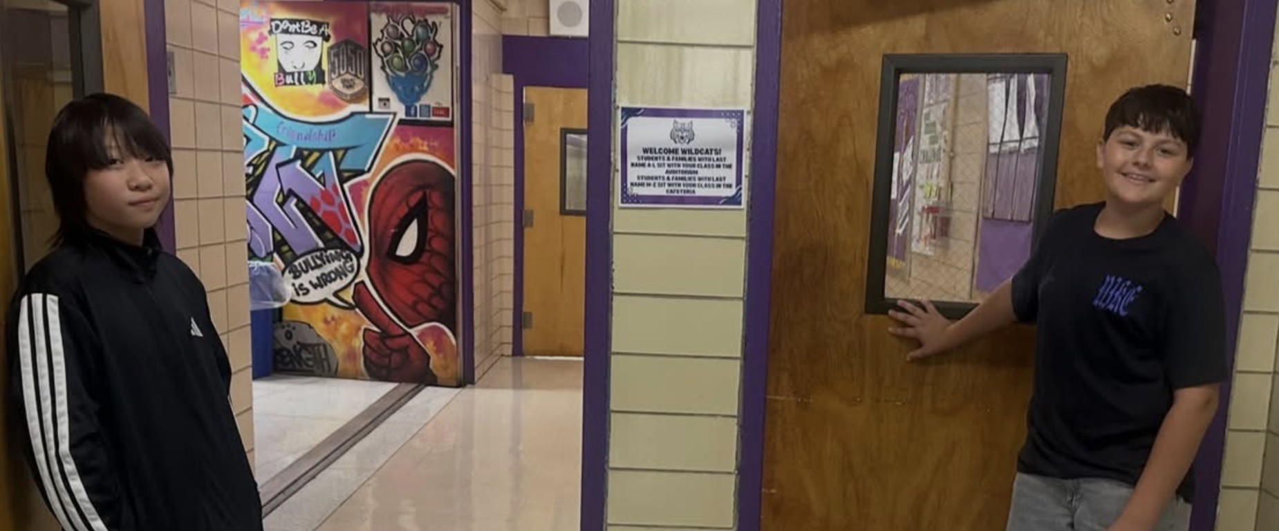 students standing at door holding door open