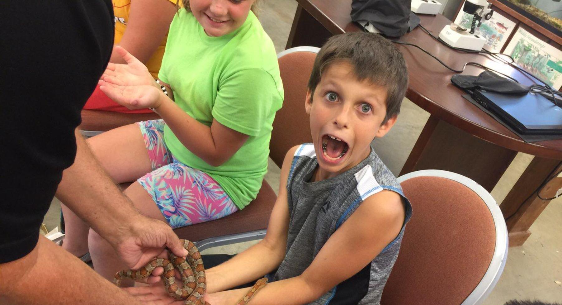 Student holding snake.