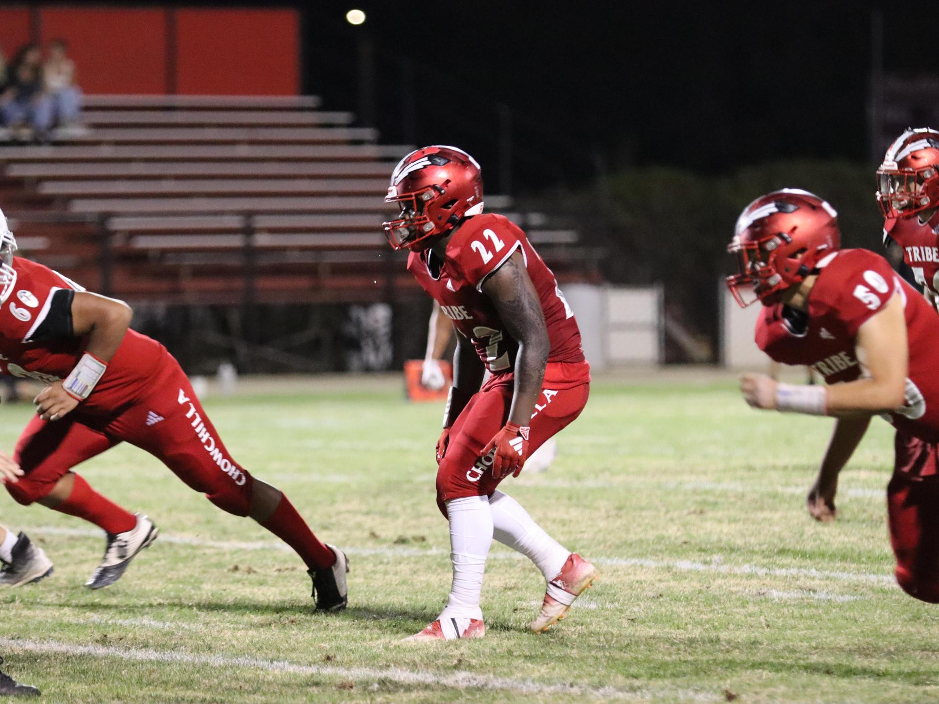 varsity football players in action against Riverdale