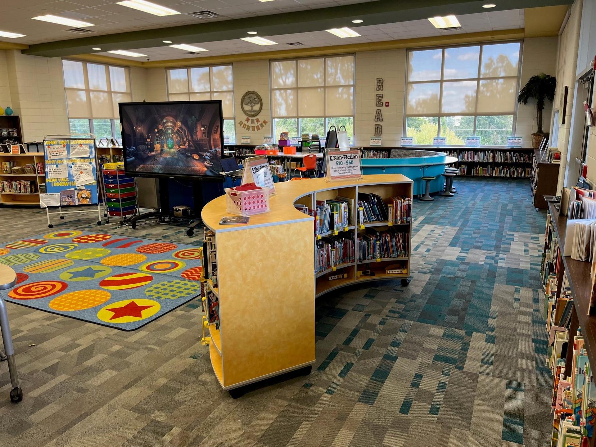 Grovetown Learning Commons space including tables, chairs, and shelves of books.