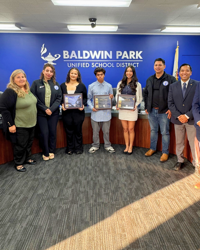 Board of Education takes a group photo with the 2026 student board members holding their certificates.