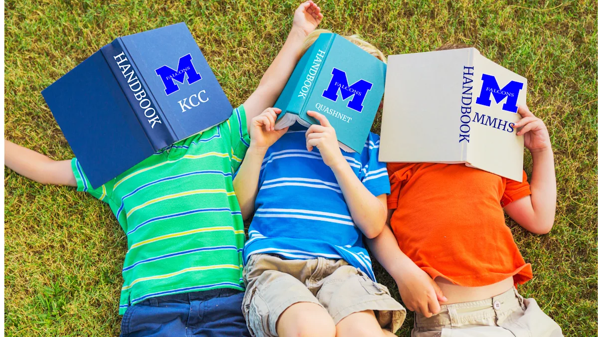 3 studnets lining on the grass with Mashpee handbooks covering their faces 