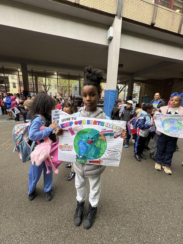 Student with his earth day poster
