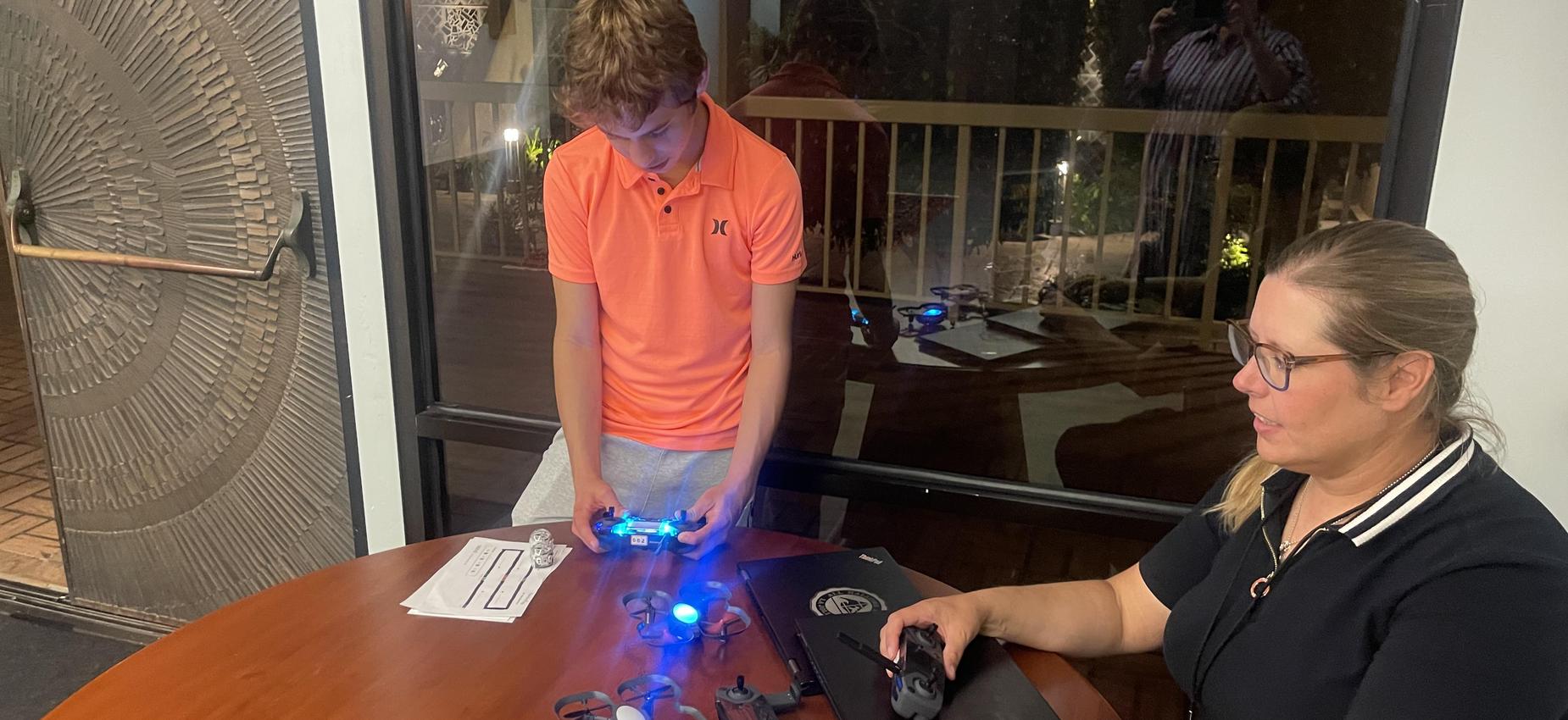 student flying a drone