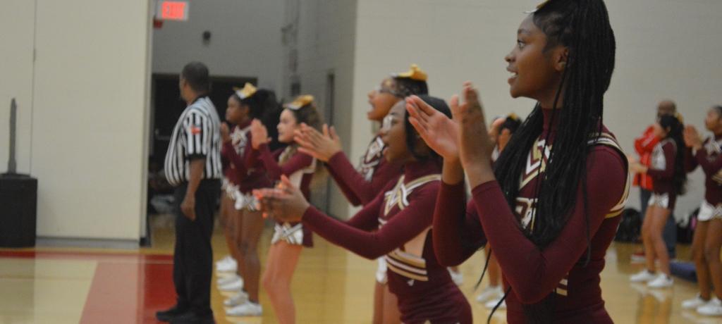 line of cheerleaders clapping