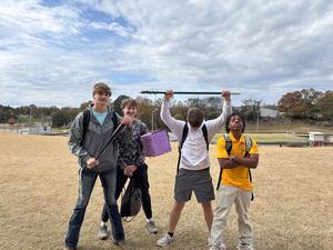 Students holding up their pinata
