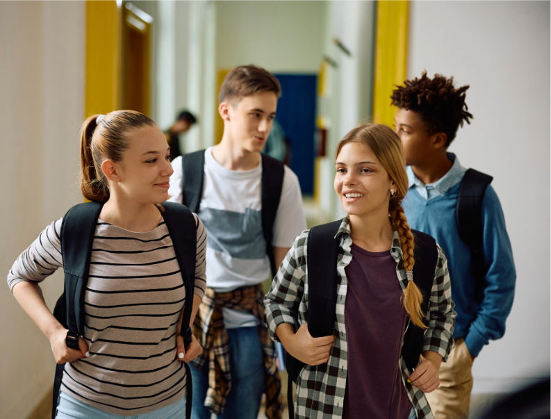 Students walk down a hall at school