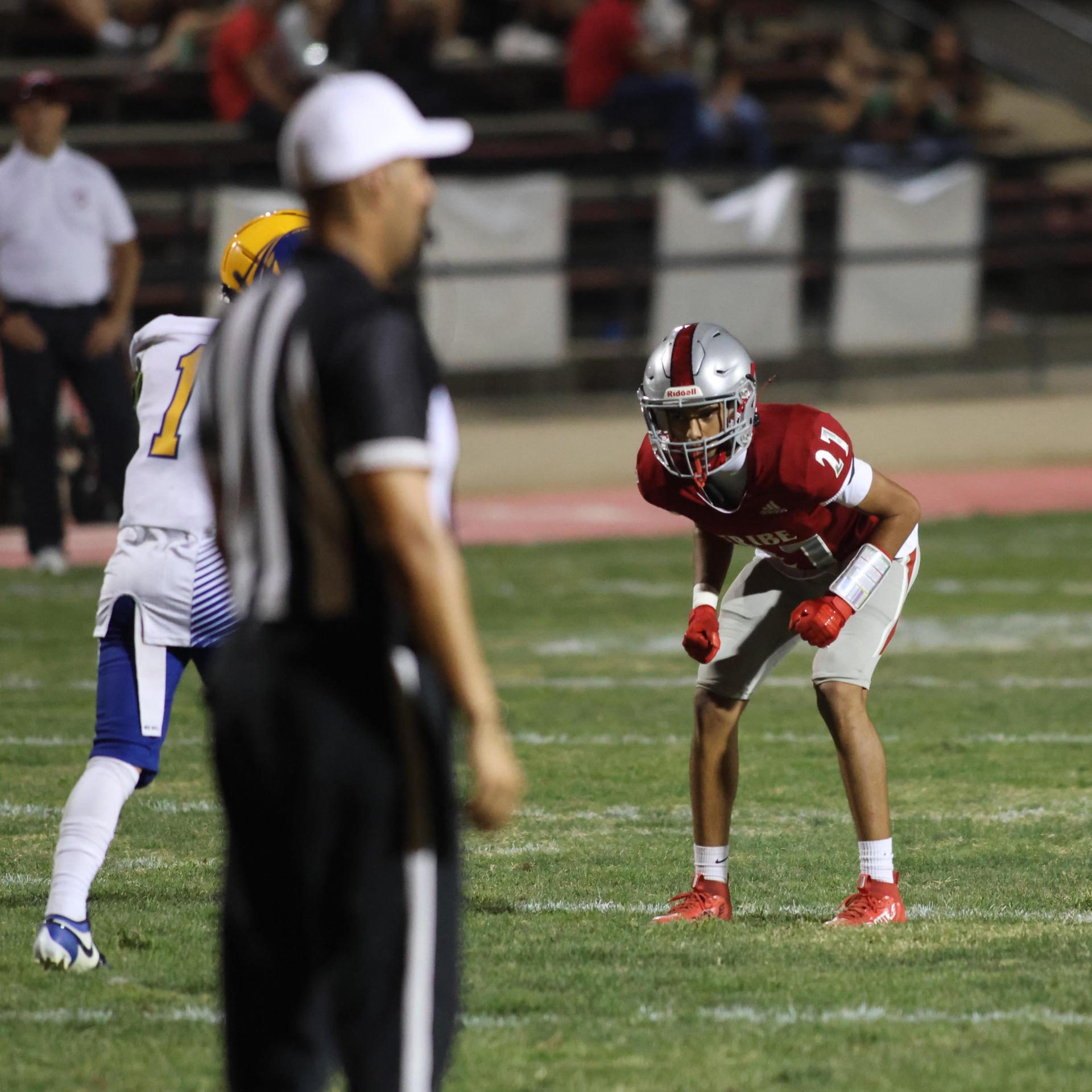 Varsity football players in action against Parlier 154