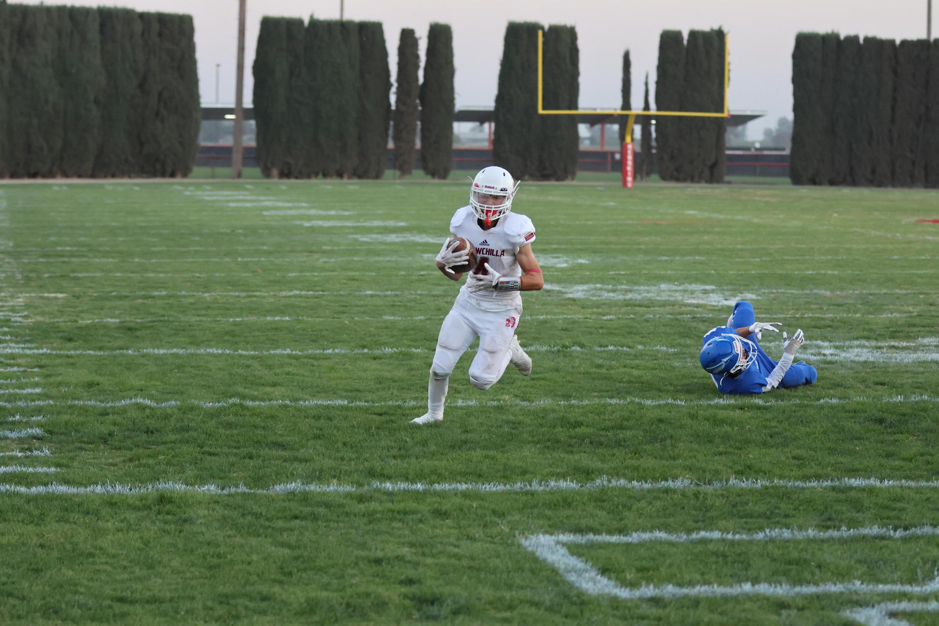 Junior Varsity football players in action against Caruthers