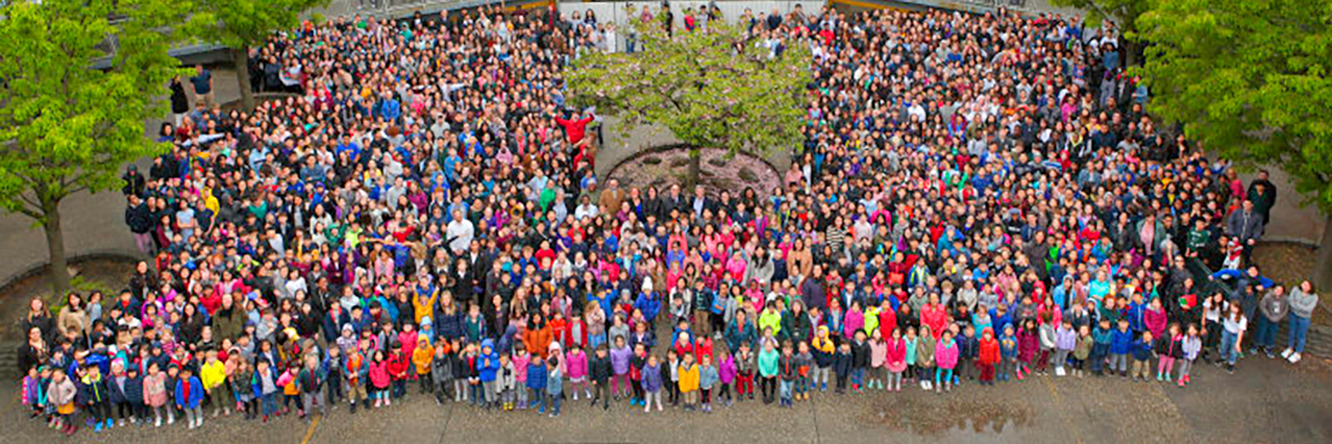 Photo of students and staff standing in the Courtyard.