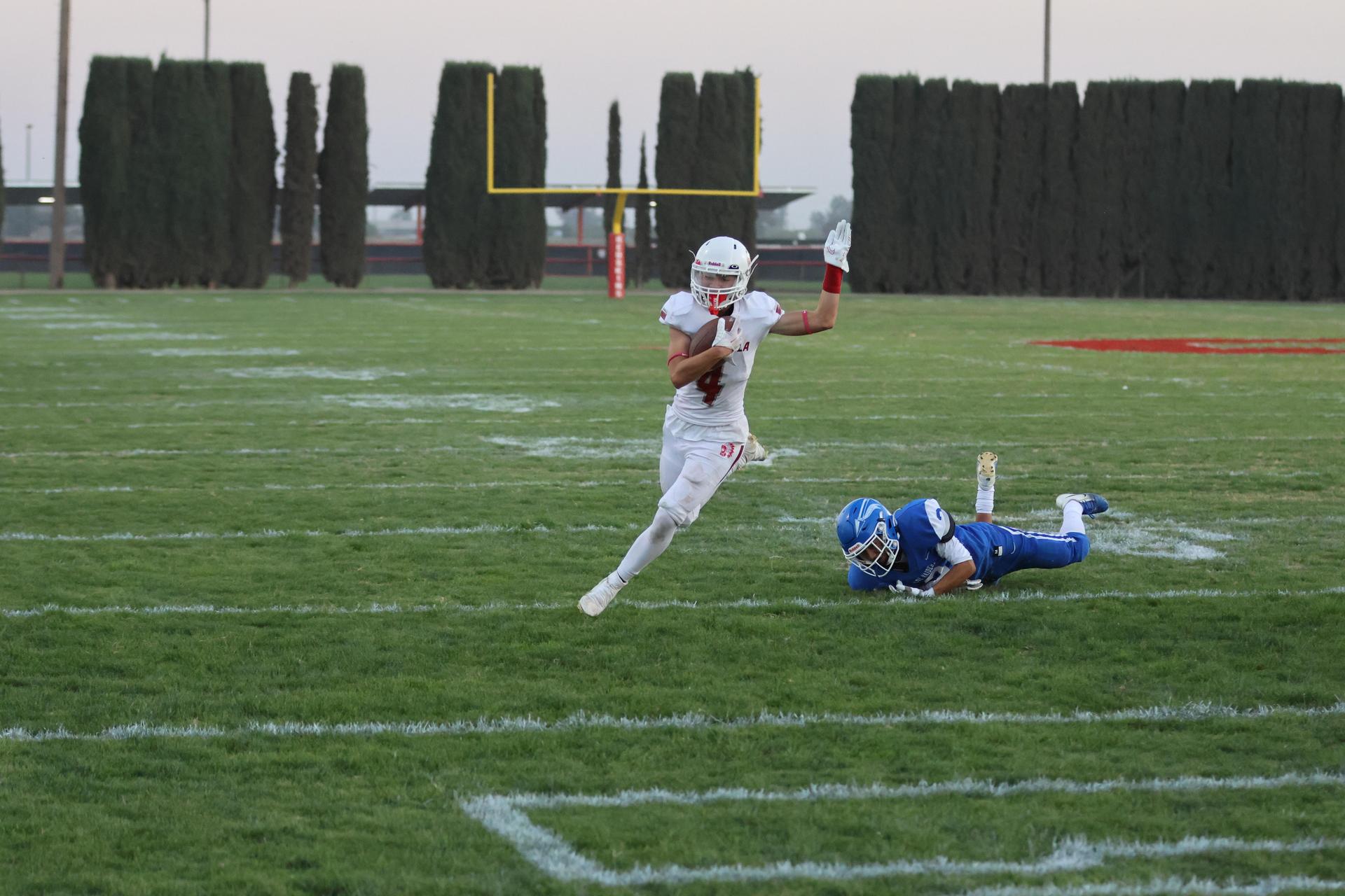 Junior Varsity football players in action against Caruthers