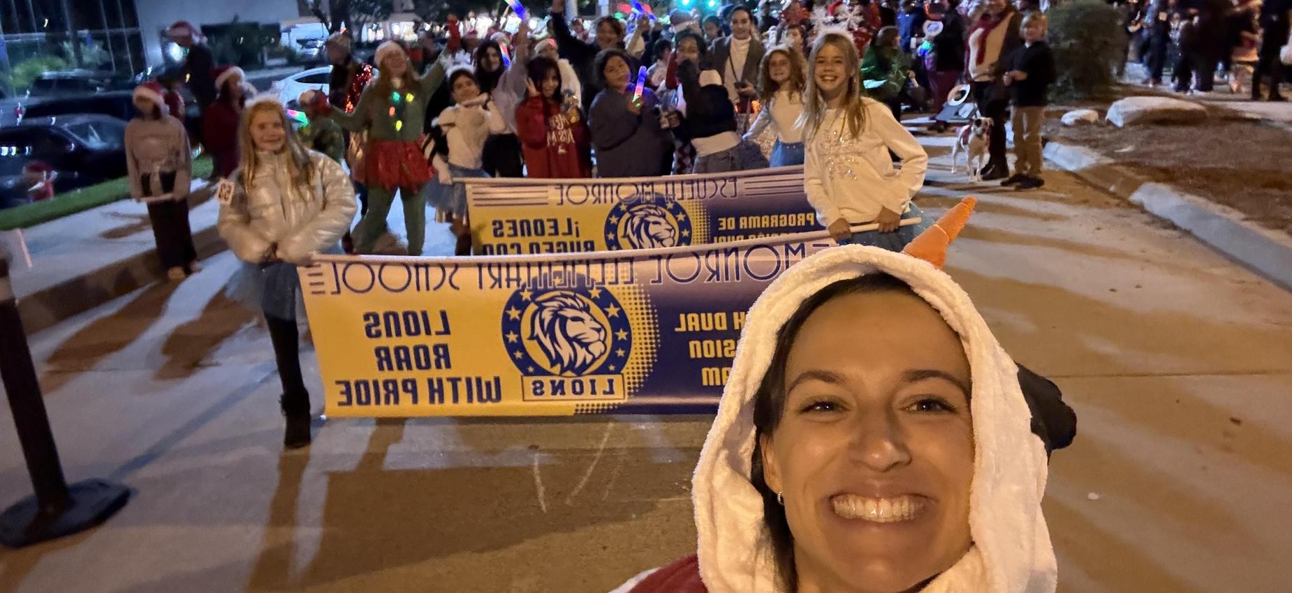 A joyful parade with participants holding banners, festive lights, and cheerful faces.