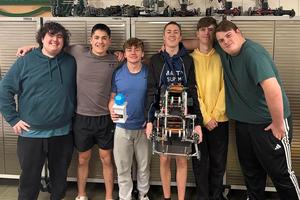 a photo of the robotics team with the trophy