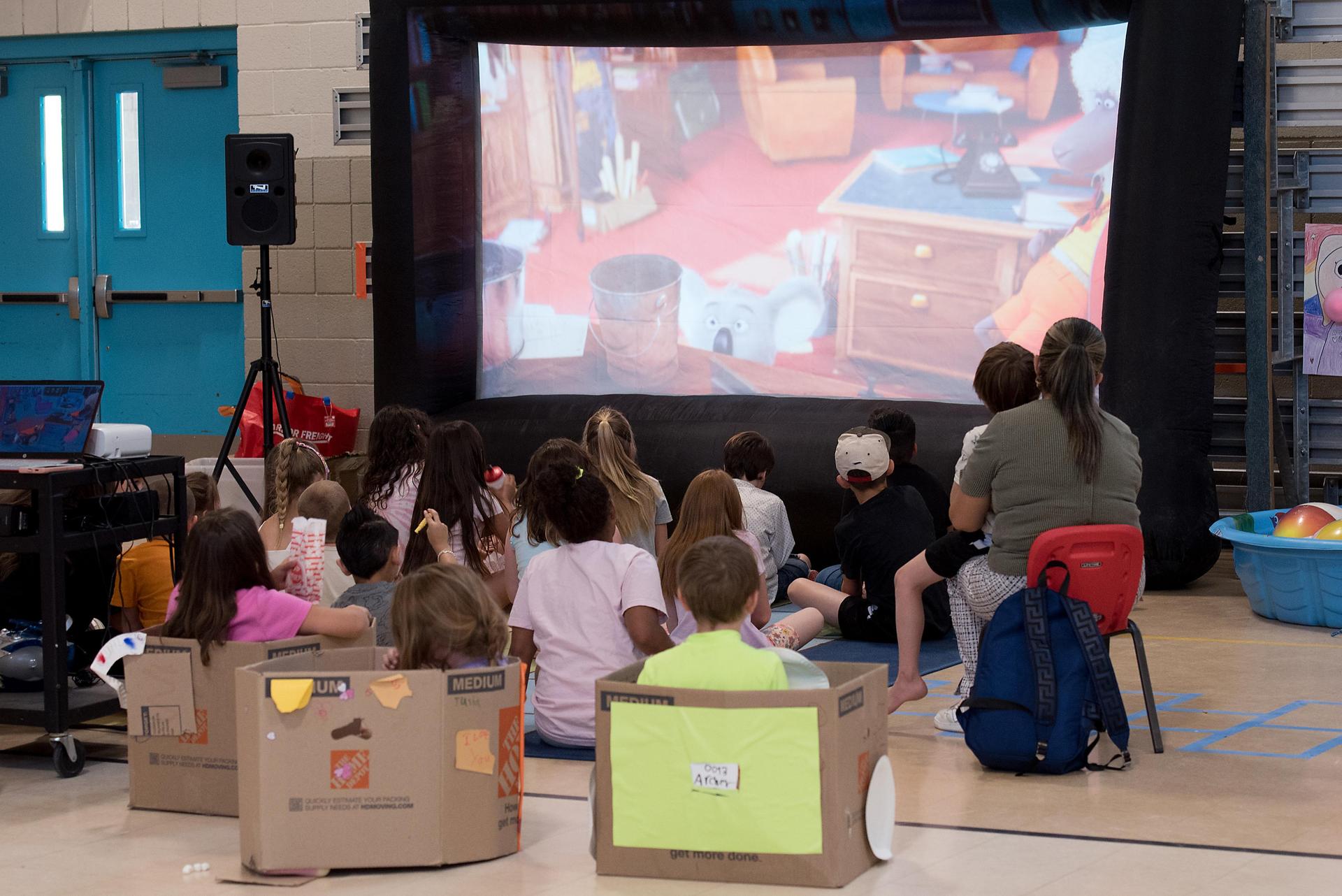 students watching a movie in cardboard cars
