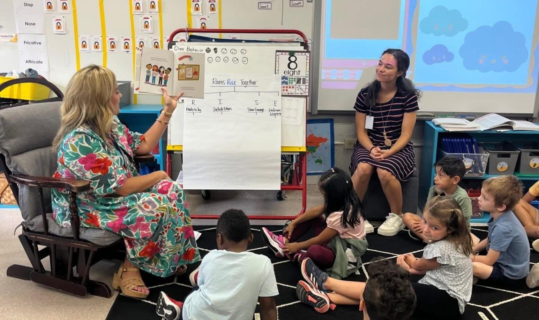Mrs. Eaton reading a book to Ms. Lotter's class