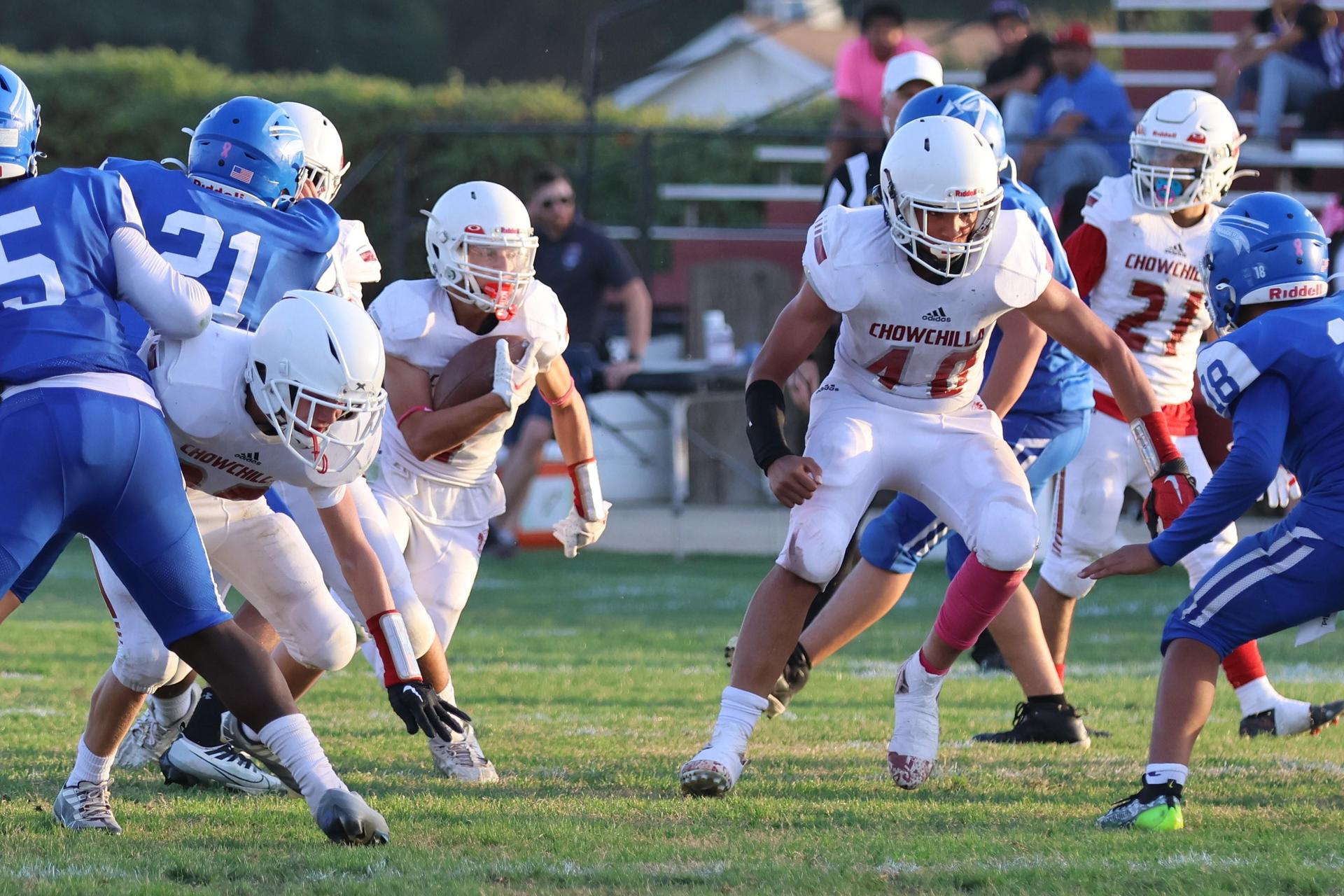 Junior Varsity football players in action against Caruthers