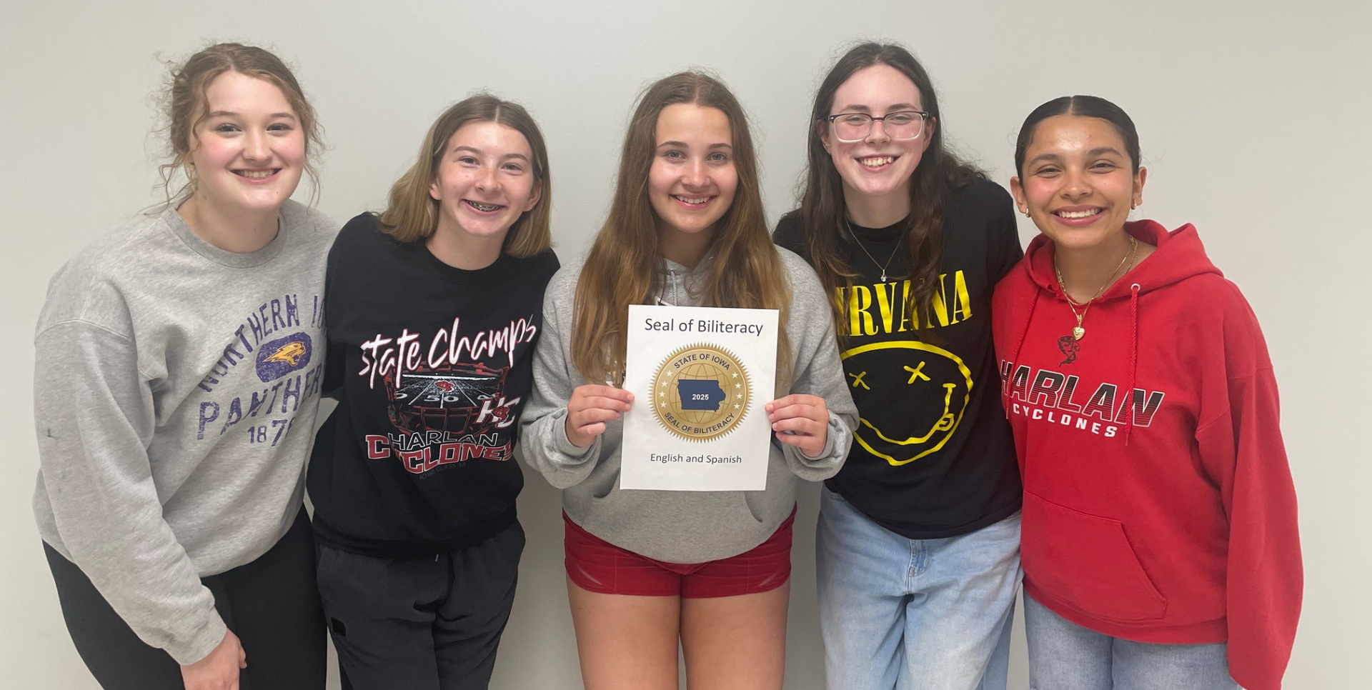 Five teens displaying a Seal of Biliteracy award.
