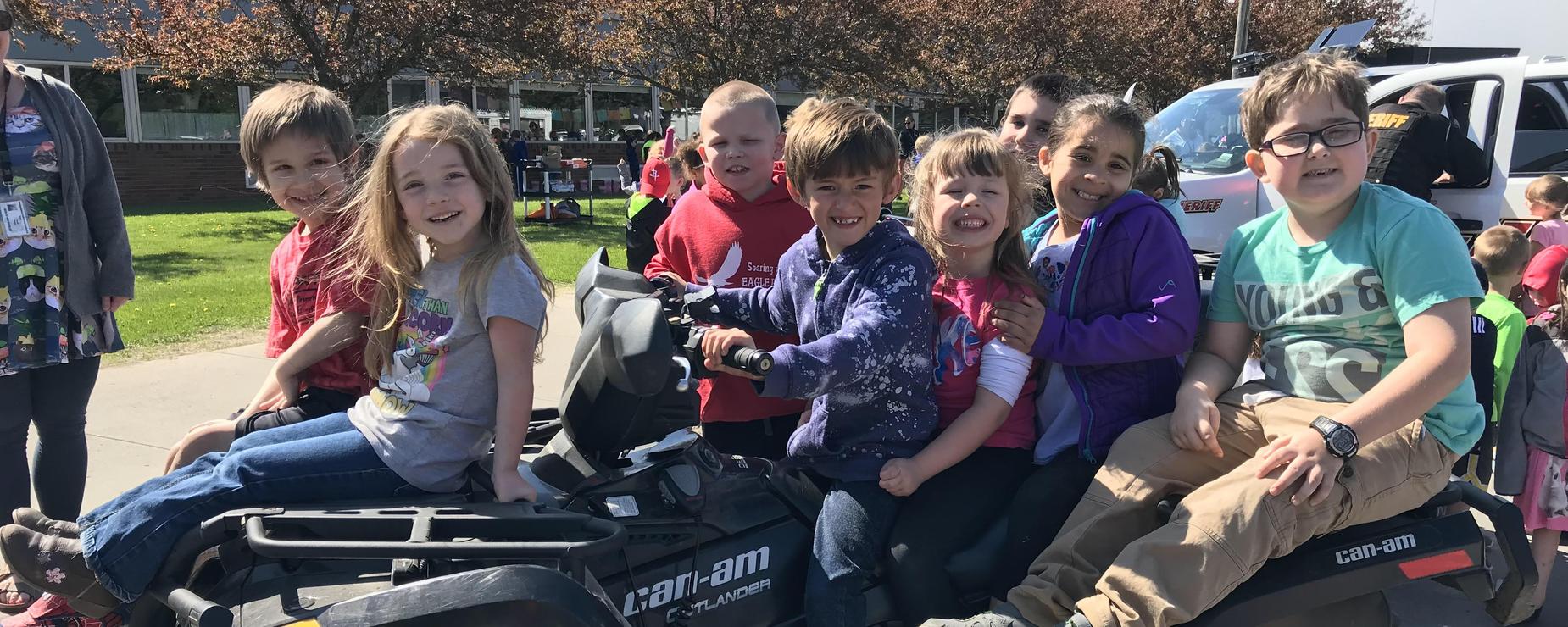 Students sitting on a 4 Wheeler
