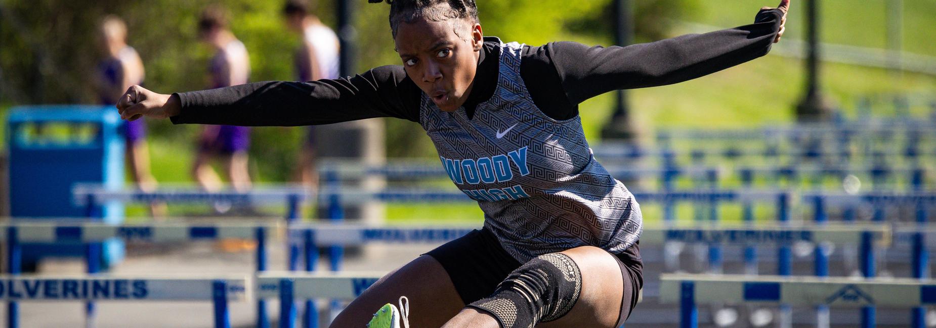 A hurdler competes