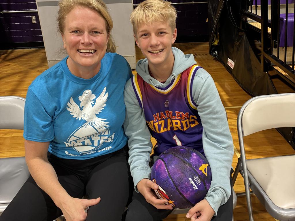 Dr. O'Connell sitting with a middle school student at the Harlem Wizards game.