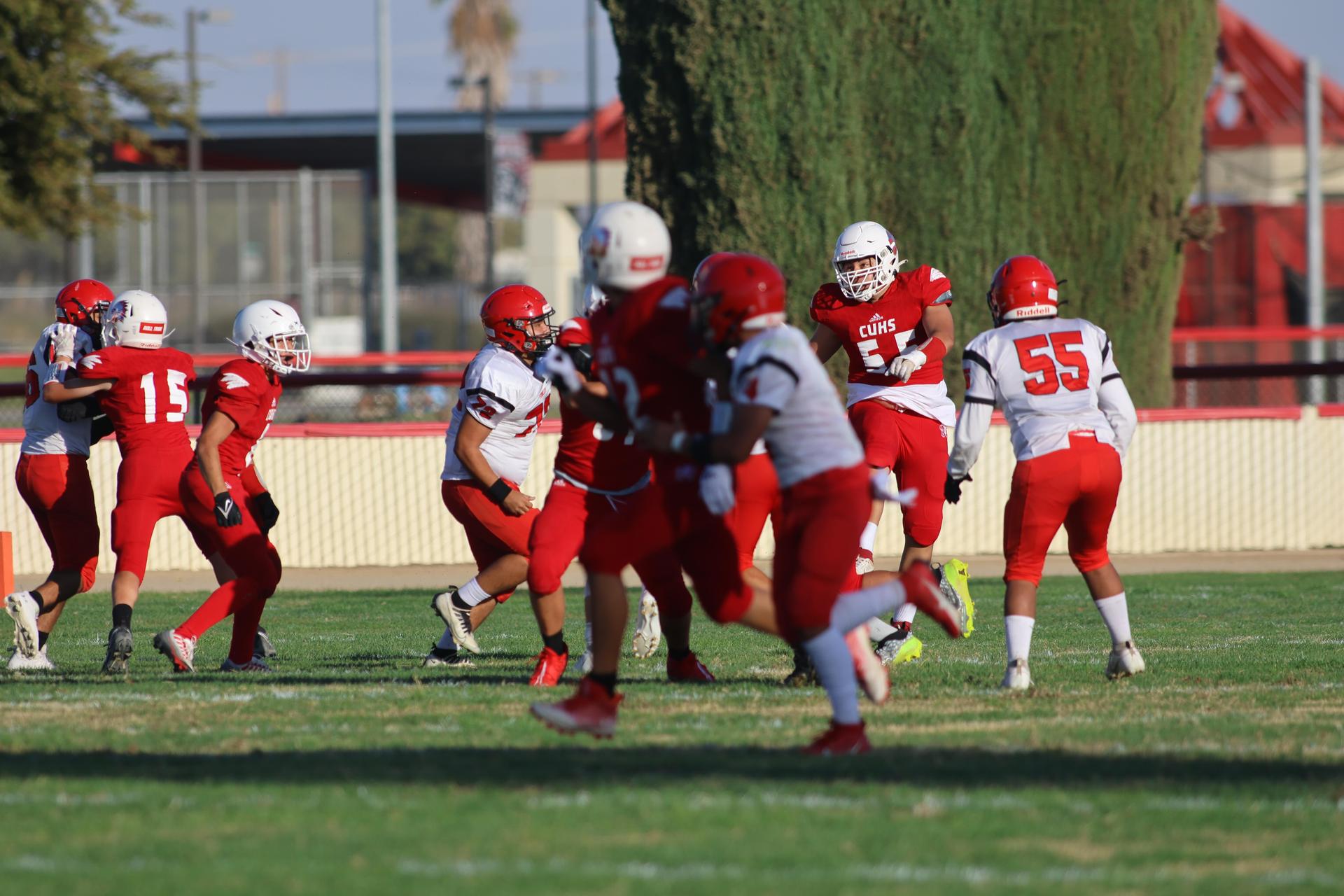 junior varsity football players in action against Fowler