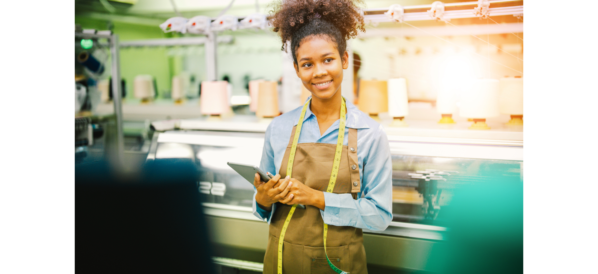 Smiling student in a sewing classroom