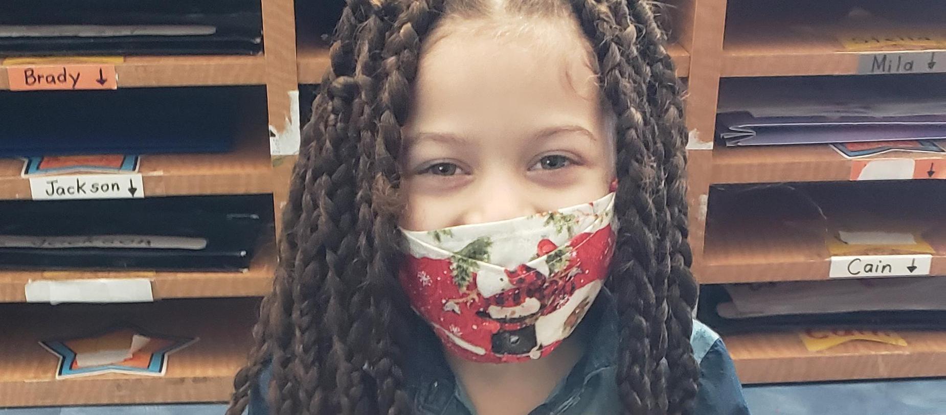 student wearing a mask posing for the camera