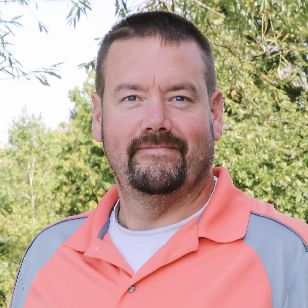 man in salmon colored polo shirt
