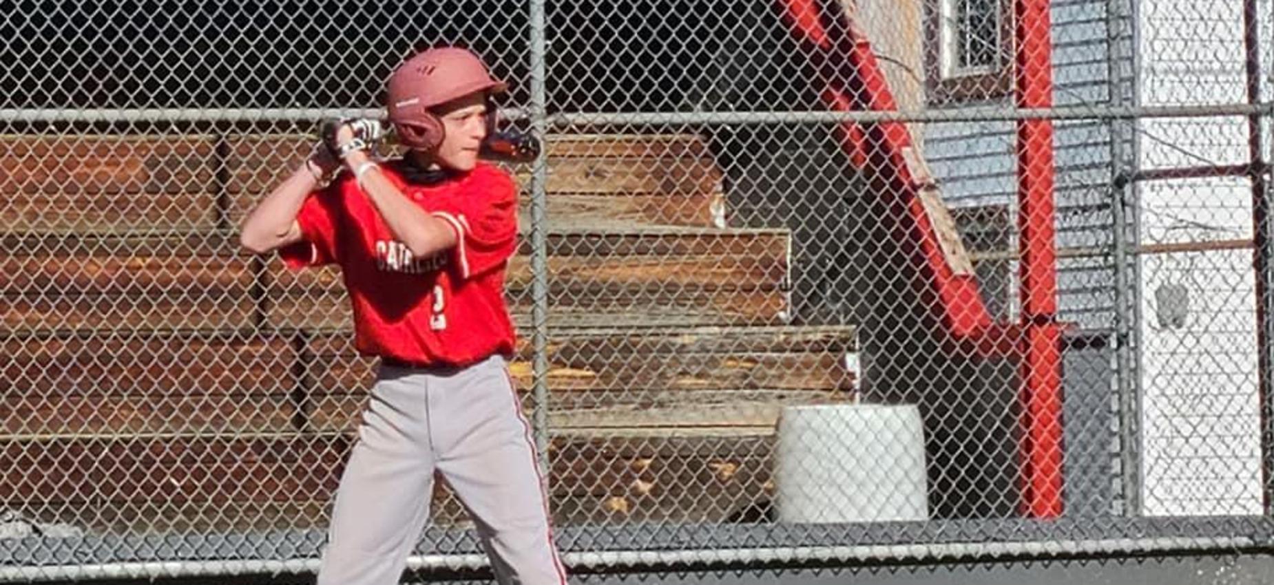 A baseball player waits for a pitch.