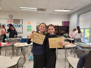 Two students work on their kever rachel projects.