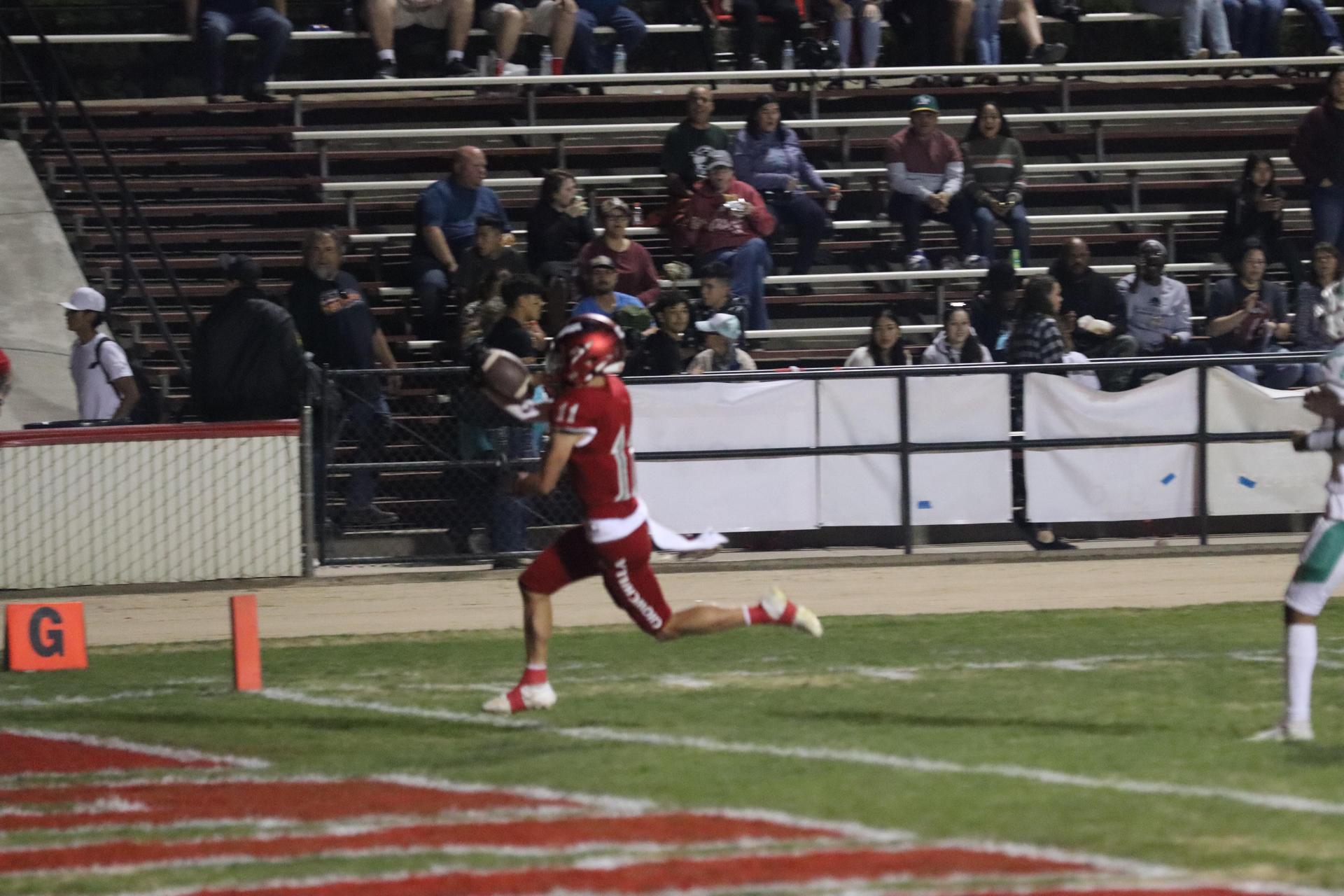 varsity football players in action against Riverdale