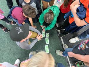 Students use their clues to spell out Book Vending Machine.
