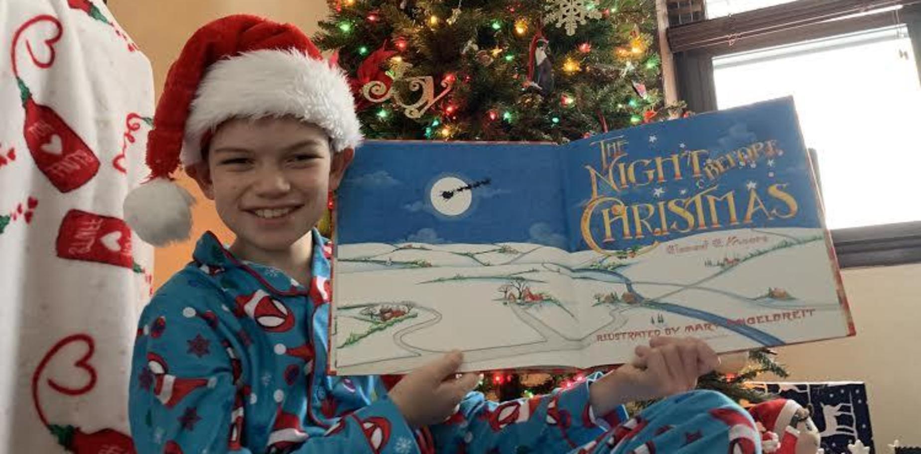 boy with book in holiday attire