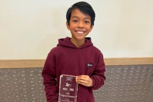Terra Vista 7th Grader Wins Regional Spelling Bee, Zian Doctolero with trophy