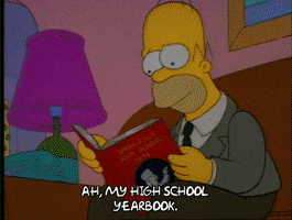 Homer reading a yearbook.