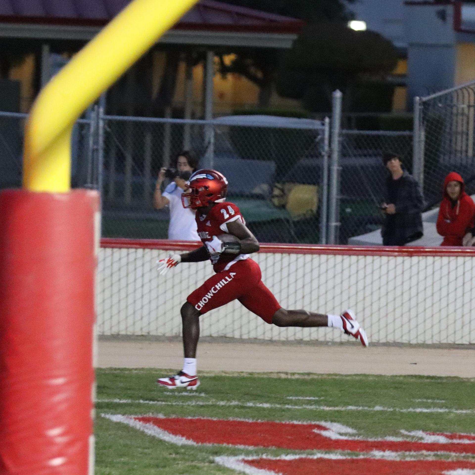 varsity football players in action against Riverdale