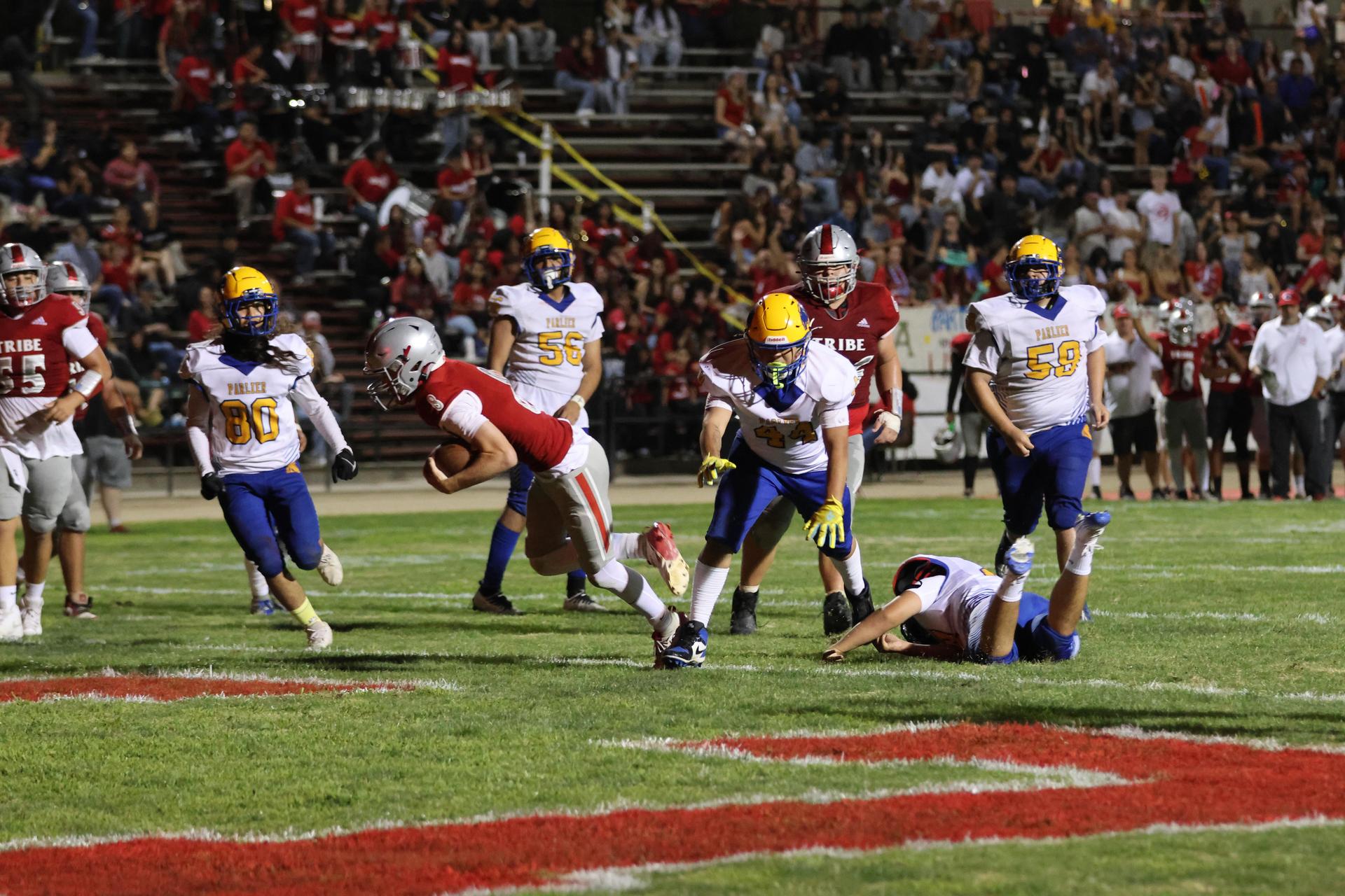 Varsity football players in action against Parlier 67