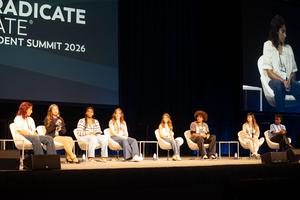 Cayden and the panelists on stage