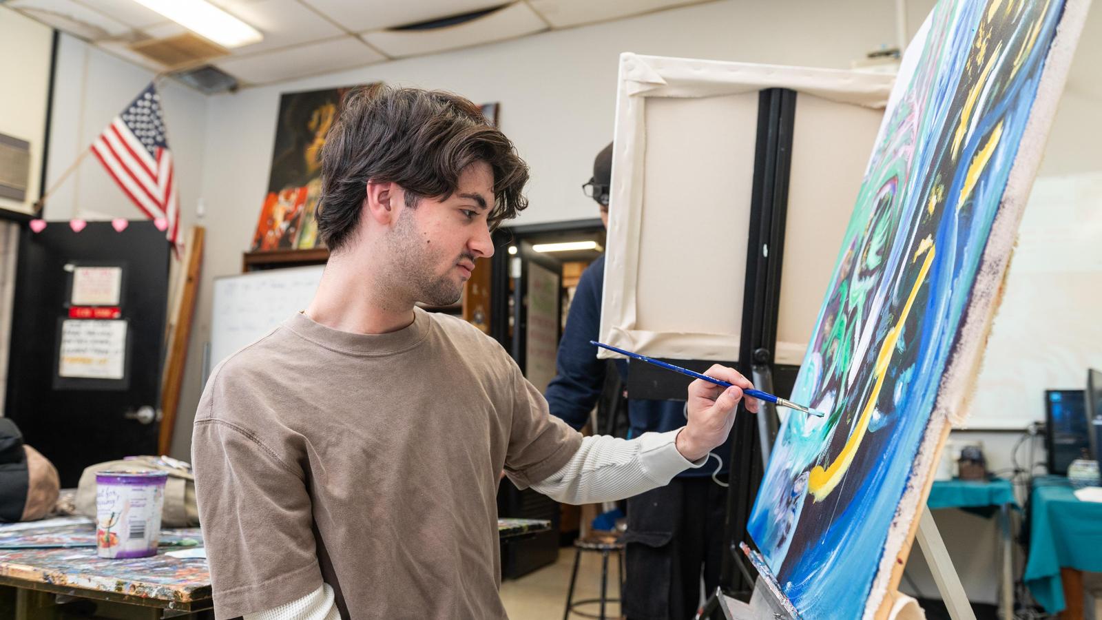 Student painting on canvas