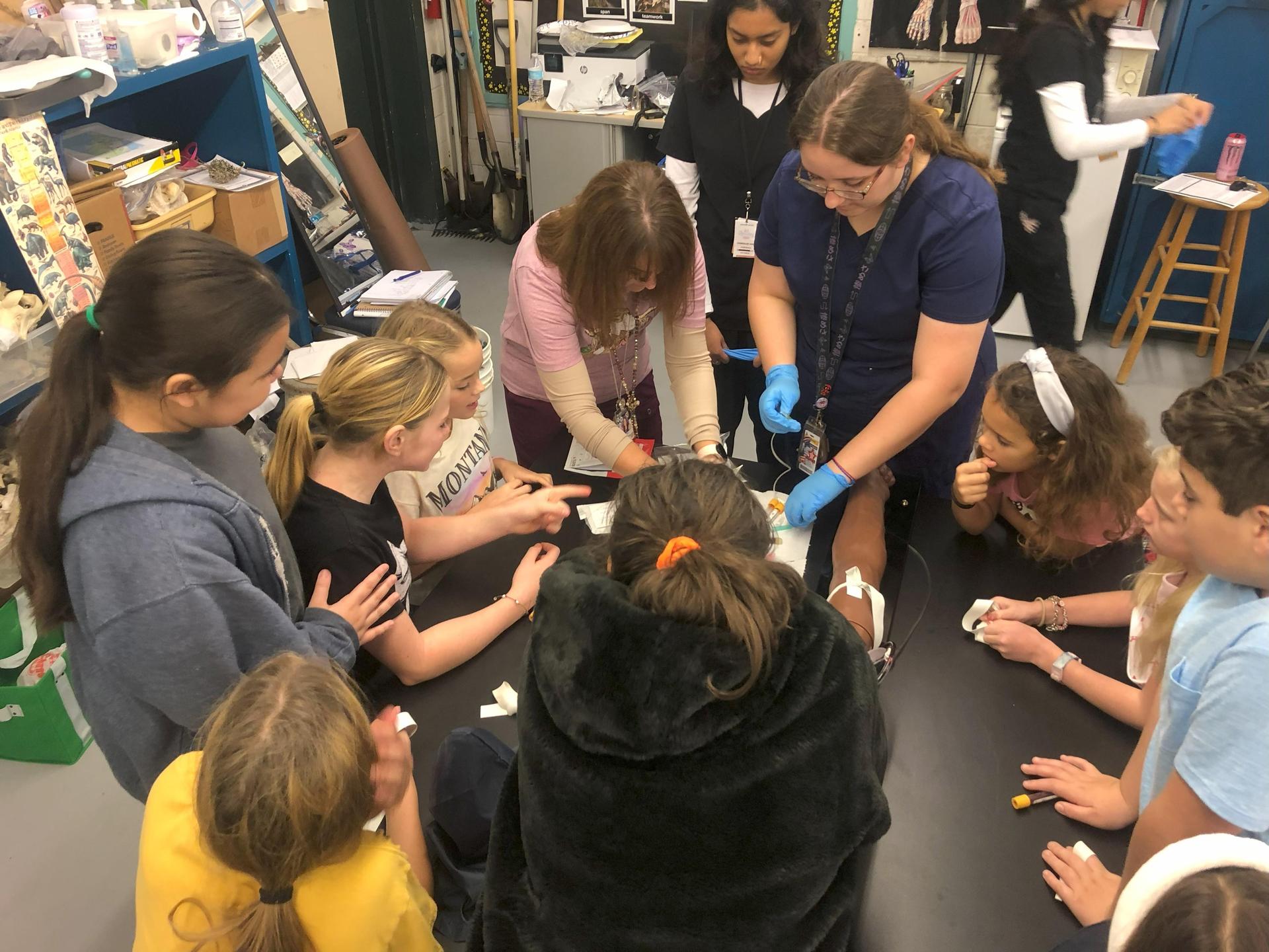 RFHS Health Science student showing Fulton Elementary students how to draw blood.