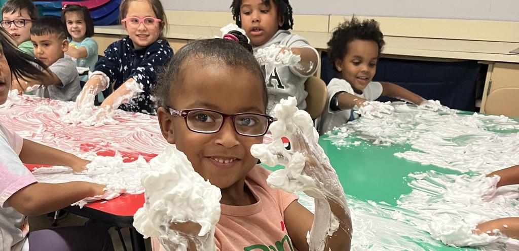 Child drawing with shaving cream.