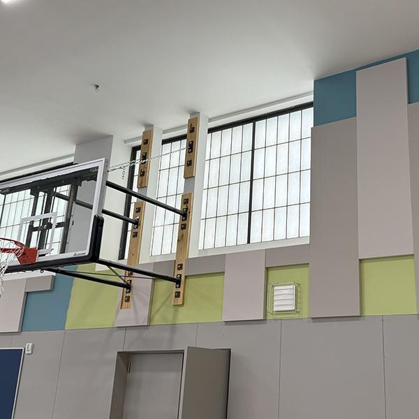 fresh paint and acoustic panels cover renovated gym walls