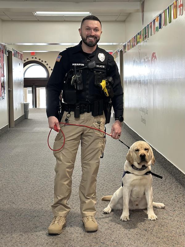 Police officer and K9 dog in a school.