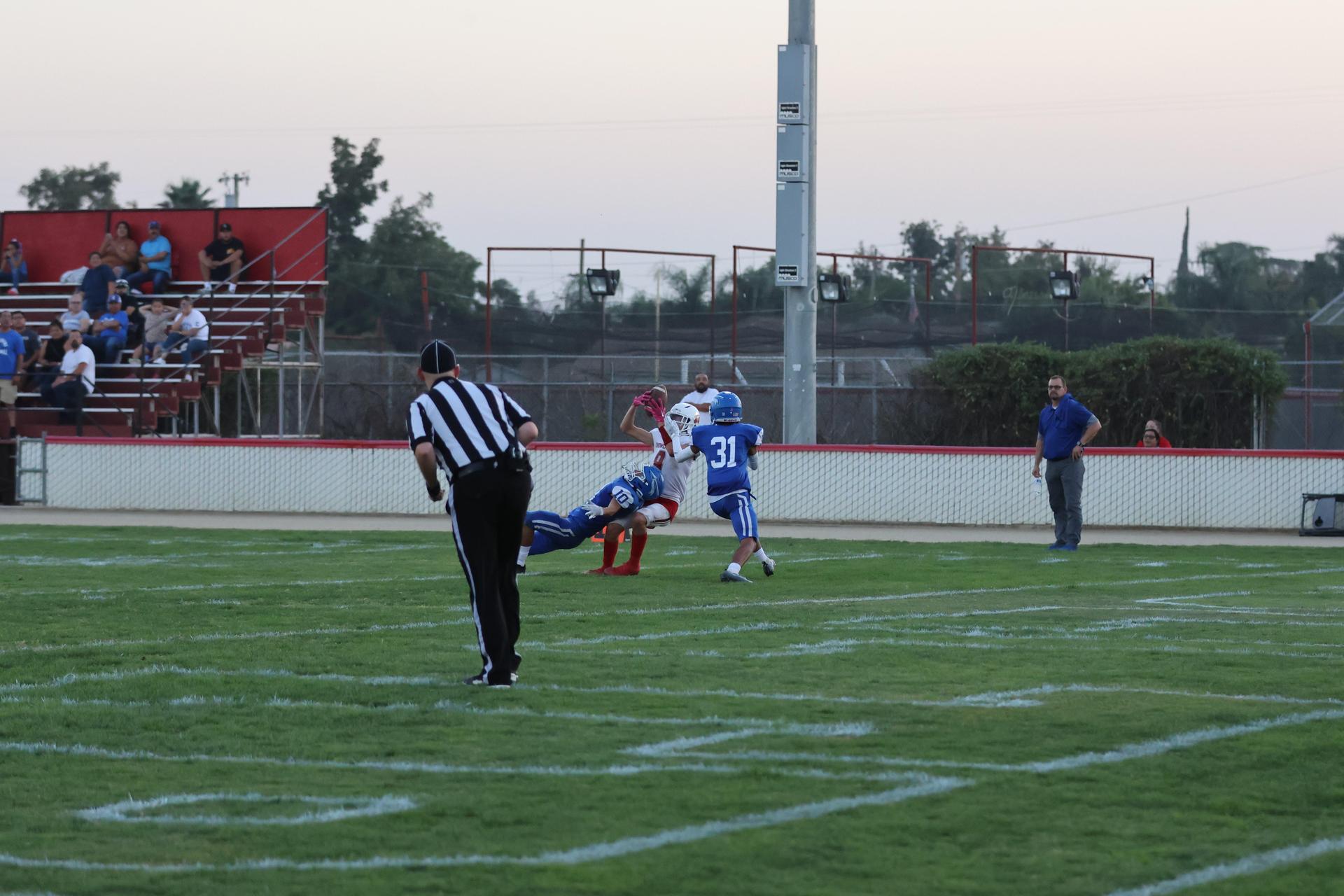 Junior Varsity football players in action against Caruthers