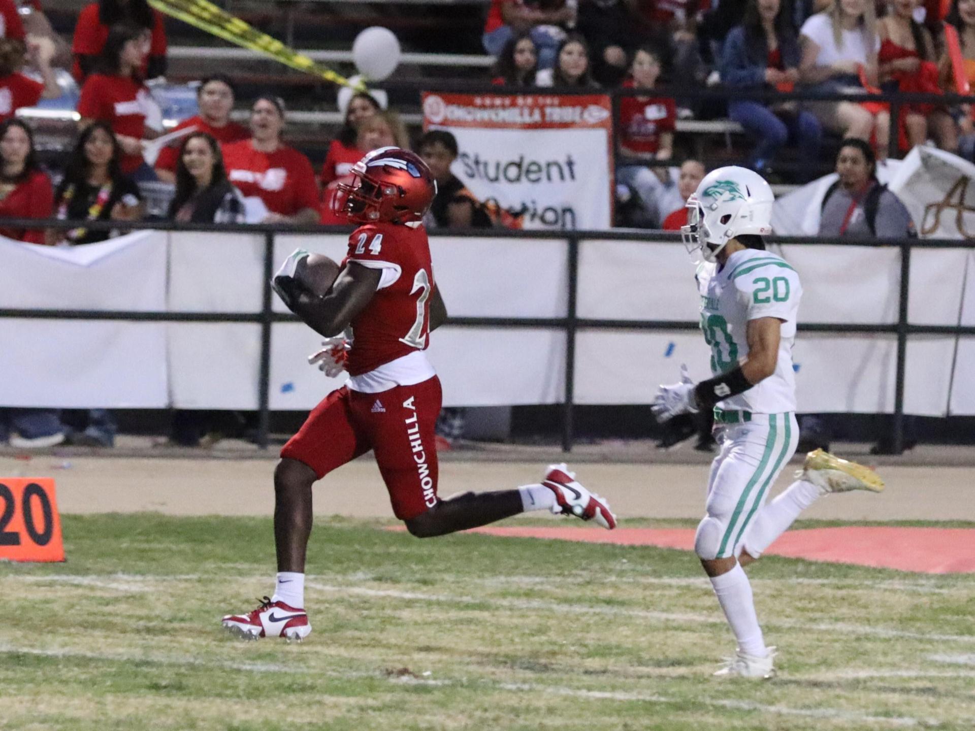 varsity football players in action against Riverdale