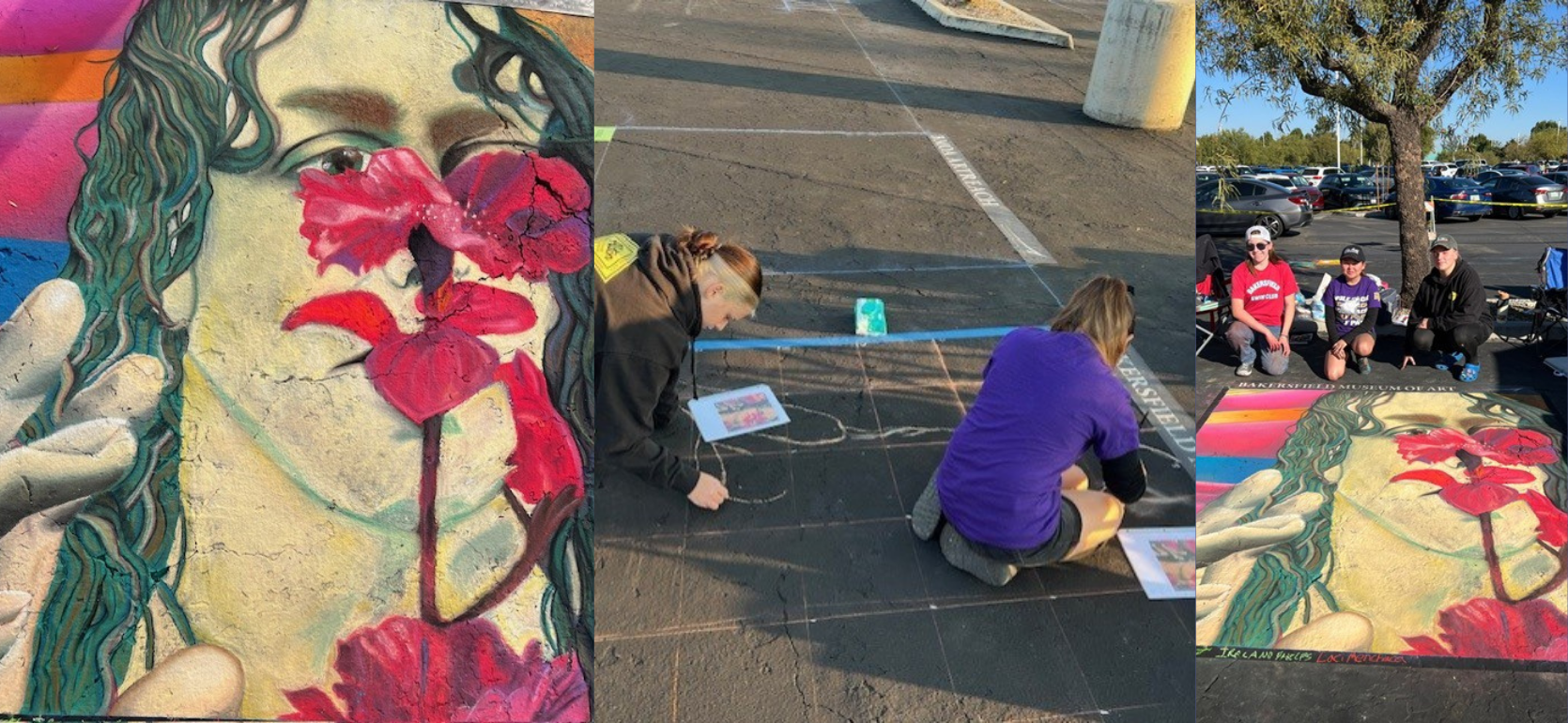 A vibrant chalk mural of a woman's face intertwined with red flowers, alongside artists at work.